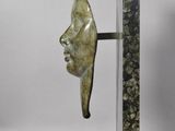 statue of a man ' s face on a marble base