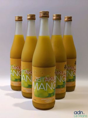 six bouteilles de jus d'orange sont alignées sur une surface blanche