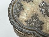 a silver box with a floral design on it
