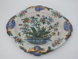 a decorative plate with flowers on it on a table