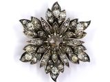 an image of a diamond flower broochle on a white background