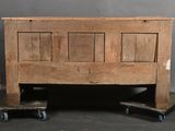 an old wooden bed with two skateboards on the floor
