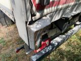 a close up of a truck ' s rear end with the door open