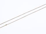 gold plated necklace with a long chain on a white background