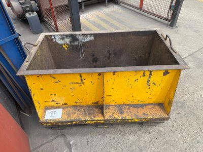 a yellow dumpster sitting on the side of the street