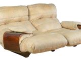 beige reclining loveseat with wooden arms and foot rest