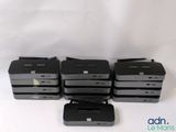 four black and gray printers sitting next to each other on a white surface