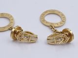two pairs of gold plated earrings on a white surface