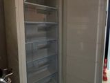 an open refrigerator in the corner of a room