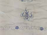 an image of a white shirt with a blue design on it