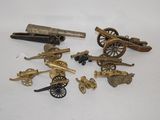 several different types of toy guns and cannon on a white surface