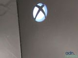 a close up of a xbox logo on the back of a laptop