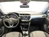 the interior of a small car with a steering wheel and dashboard
