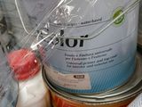 a can of paint sitting on a table next to a can of paint