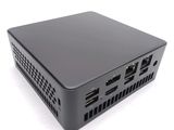 an image of a small black computer sitting on top of a white surface