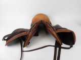 pair of brown leather saddles on a white background
