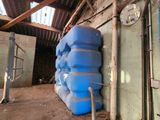 a large stack of blue barrels sitting next to each other
