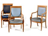 three wooden chairs with blue upholstered leather seats on a white background