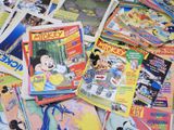 a pile of comics on a table with other comics
