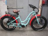 a blue and red bike parked in front of a building