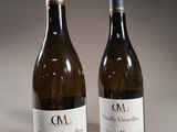 two bottles of wine sitting next to each other on a table