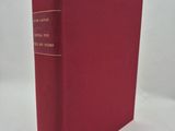a red book sitting on top of a white surface