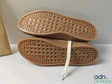 pair of brown shoes with white laces sitting on top of a white table