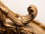 a close up of a gold vase with a bird on it