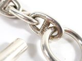 a close up of a silver chain with a key on it