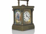 a gold clock with a picture of a woman on it