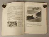 an open book with a picture of a landscape on it