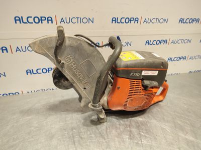a close up of a chainsaw on a table in front of a wall
