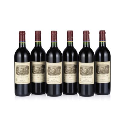 six bottles of red wine lined up in a row