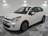 the white citrole is parked on a checkered tile floor