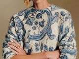 an image of a woman in a sweater and jeans