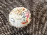 a small white bowl with a floral design on it