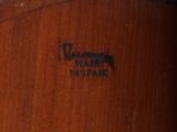 an image of a close up of a wooden chair with a label on it