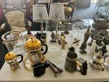 a table with a lot of silver and gold items on it