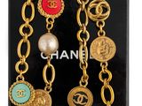 a close up of a chanel bracelet with pearls and charms