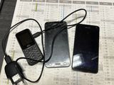 a cell phone and a charger sitting on a table