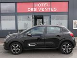 La petite voiture est garée devant l'hôtel, devant le bâtiment.