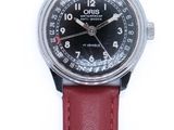 a close up of a wrist watch on a white surface
