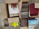 a lot of records in a box on the floor