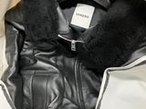 the jacket is black and white and has a fur collar