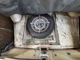 underside view of a car with a tire and a flat tire