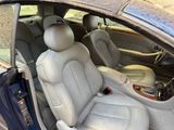the interior of a car with the door open and the passenger seat down