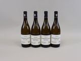 three bottles of wine sitting on top of a white table