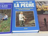 three books on a white table with a man and a dog