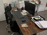 a desk with a computer and a keyboard on it