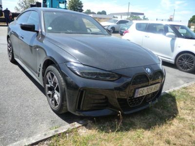 the bmw g8 sedan is parked on the side of the road